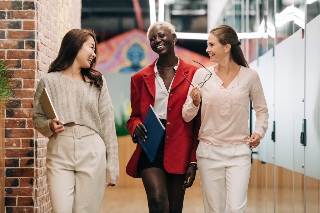 three women talking and laughing at work